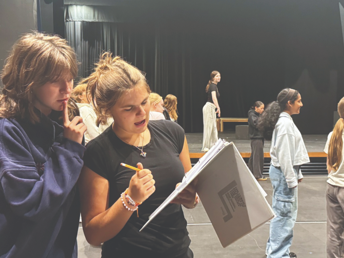 Anabel Adams '25 and Georgia Morton '25 review lines during rehearsal.